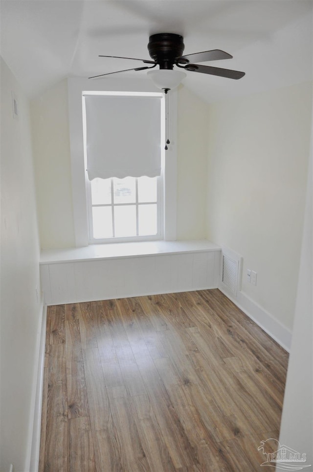 4565 Forsyth St, Bagdad, FL 32583 - spare room with ceiling fan, wood finished floors, and vaulted ceiling
