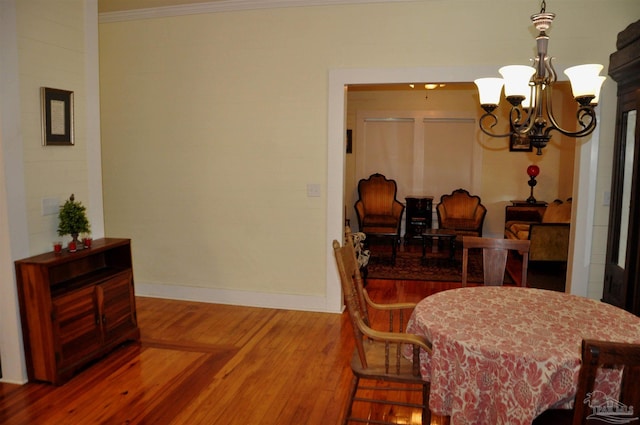 4565 Forsyth St, Bagdad, FL 32583 - dining space featuring a chandelier, wood finished floors, ornamental molding, and baseboards