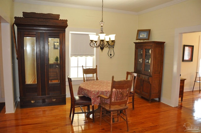 4565 Forsyth St, Bagdad, FL 32583 - dining room featuring wood finished floors, a chandelier, ornamental molding, and baseboards