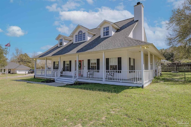 country-style home featuring fence, a porch, a chimney, a shingled roof, and a front lawn