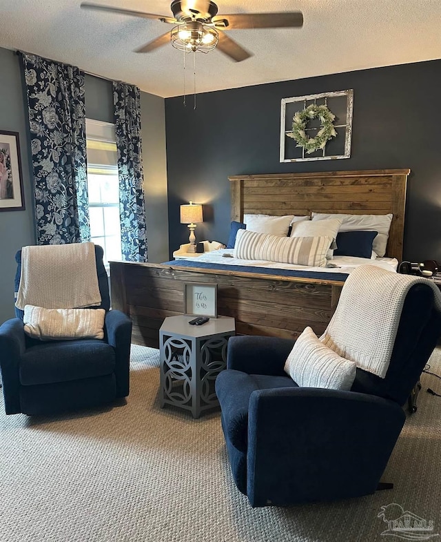 bedroom with ceiling fan, carpet flooring, and a textured ceiling