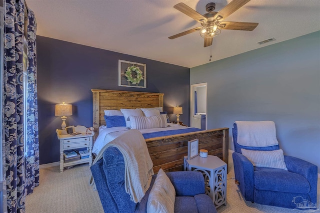 carpeted bedroom featuring visible vents, baseboards, a textured ceiling, and a ceiling fan
