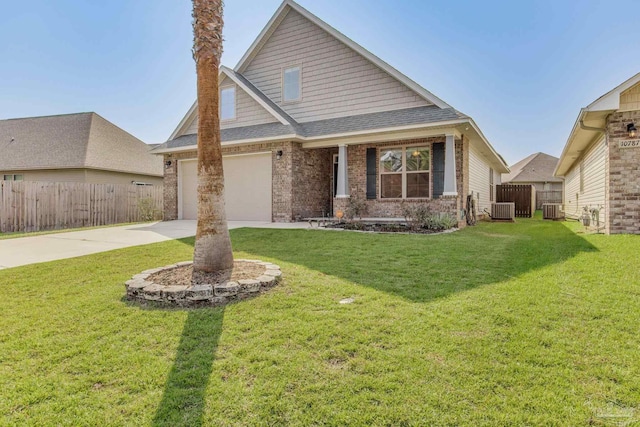 craftsman-style house with a front lawn, central air condition unit, and a garage