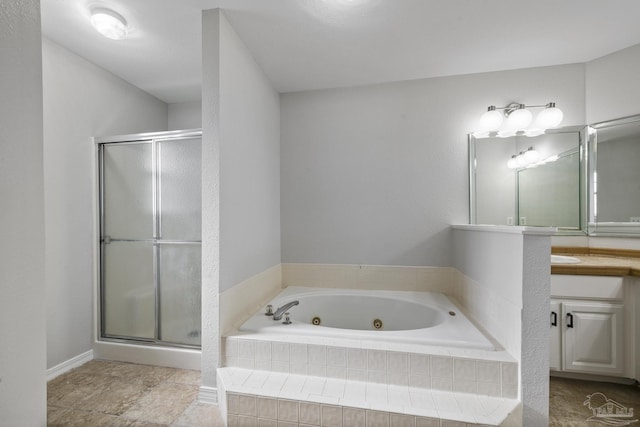 bathroom featuring a shower stall, vanity, and a tub with jets