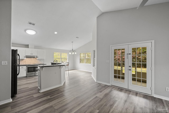 kitchen featuring white cabinets, electric stove, freestanding refrigerator, dark wood-style floors, and dark countertops