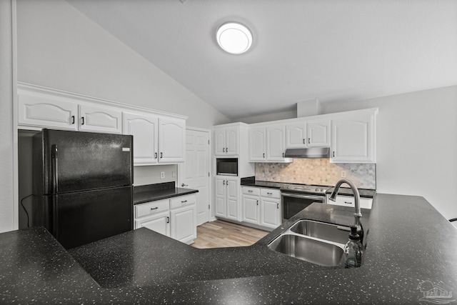 kitchen with lofted ceiling, under cabinet range hood, a sink, white cabinetry, and black appliances