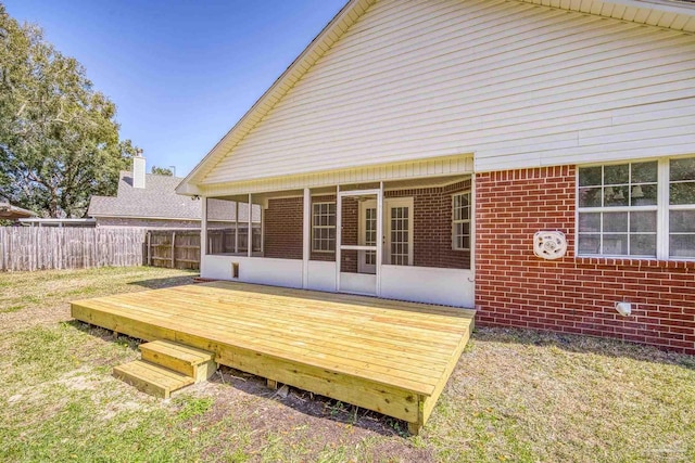 deck with a sunroom and fence