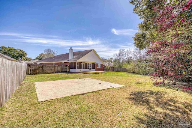 view of yard with a fenced backyard and a patio