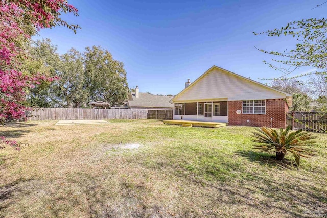 view of yard featuring a fenced backyard and a sunroom