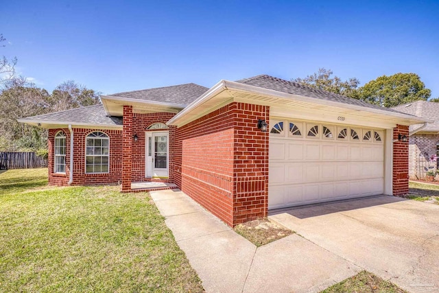 ranch-style house featuring driveway, roof with shingles, an attached garage, a front lawn, and brick siding