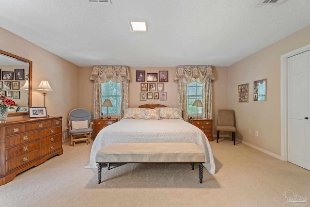 carpeted bedroom with a textured ceiling