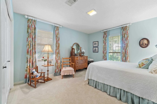 carpeted bedroom featuring a textured ceiling and a closet