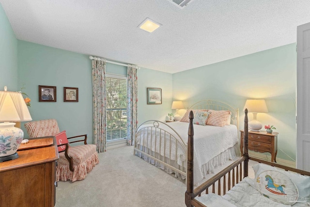 bedroom with light carpet and a textured ceiling