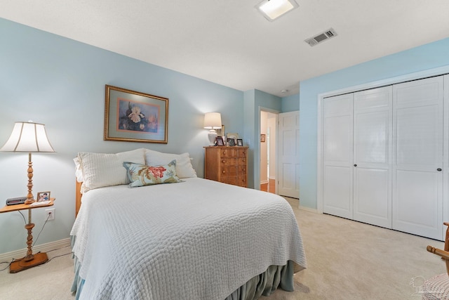 bedroom featuring light carpet and a closet