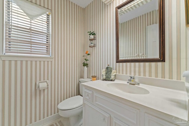 bathroom featuring tile patterned flooring, vanity, and toilet