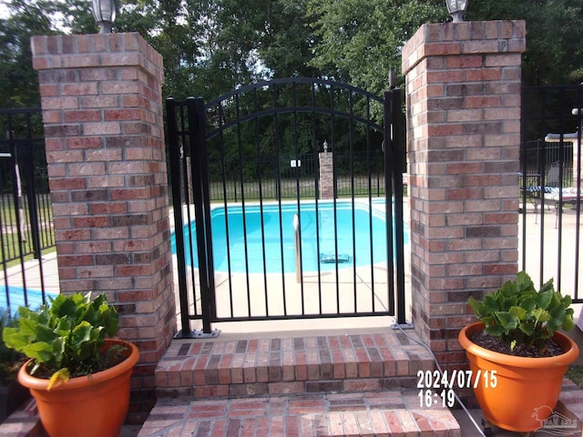 view of gate featuring fence
