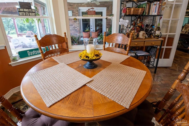 dining space featuring brick floor