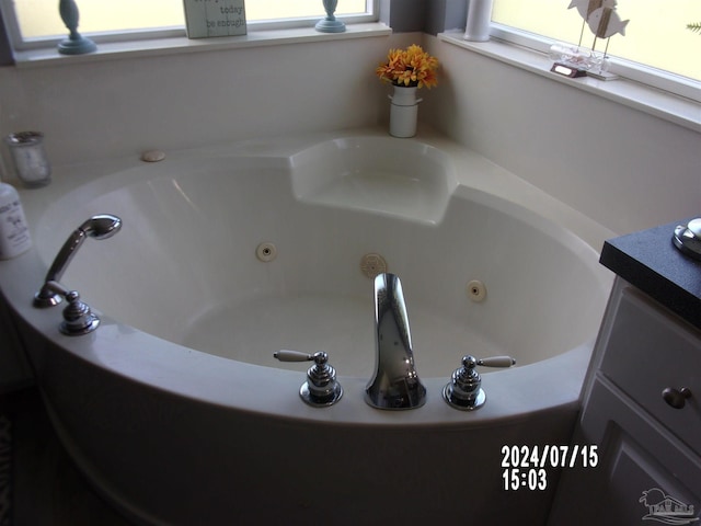 full bath with a tub with jets