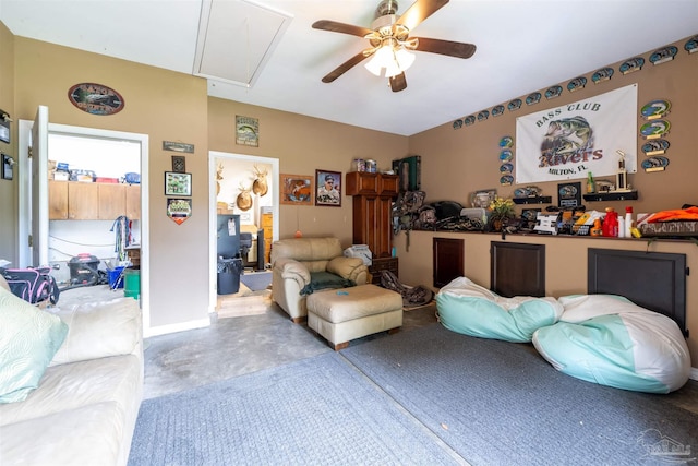 living room with lofted ceiling, finished concrete floors, attic access, and ceiling fan
