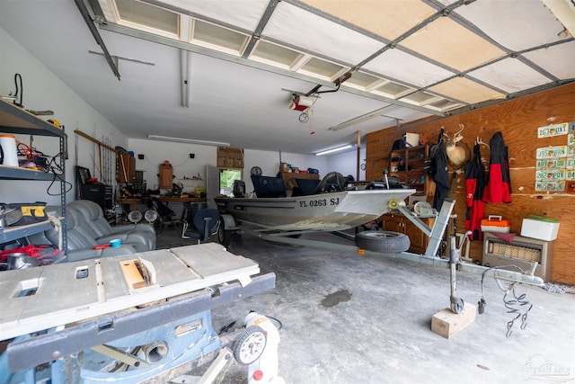 garage with a garage door opener and a workshop area