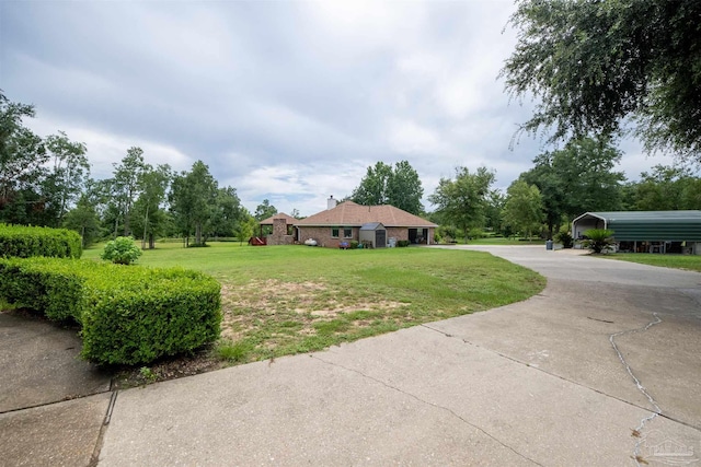exterior space with a detached carport and concrete driveway