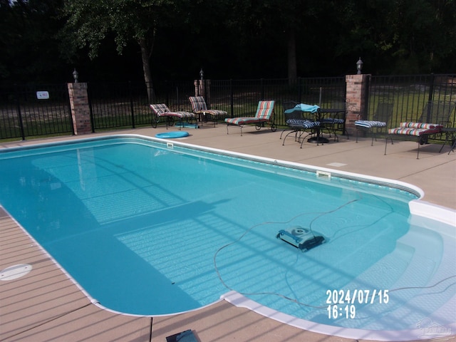 view of swimming pool with a patio, a fenced in pool, and fence