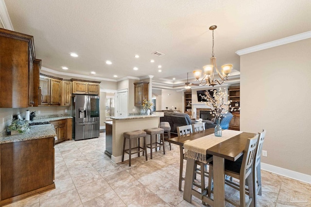 tiled dining space with a chandelier, a textured ceiling, crown molding, and sink