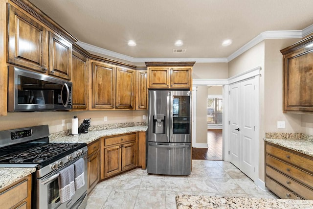 kitchen featuring light stone countertops, stainless steel appliances, ornamental molding, and light hardwood / wood-style floors