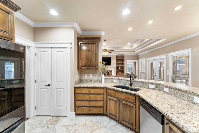 kitchen featuring appliances with stainless steel finishes, french doors, a textured ceiling, crown molding, and sink