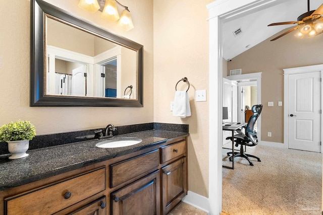 bathroom featuring vanity, ceiling fan, and lofted ceiling