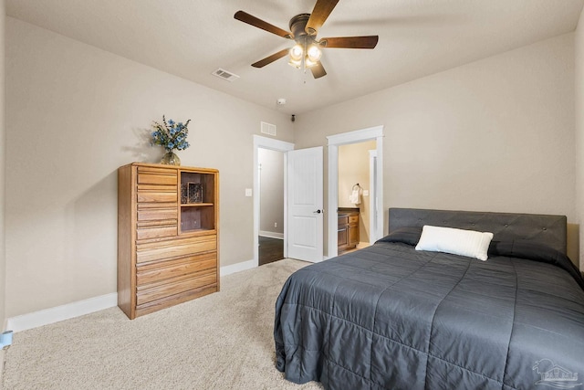 bedroom with carpet flooring, ceiling fan, and ensuite bathroom