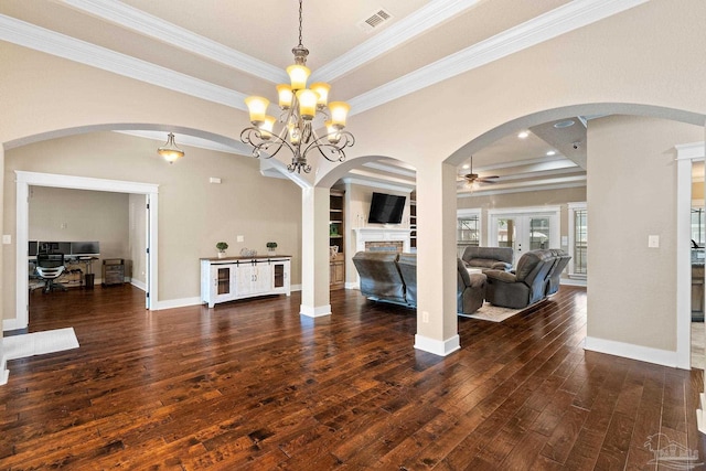 interior space with ornamental molding, dark wood-type flooring, a tray ceiling, and french doors