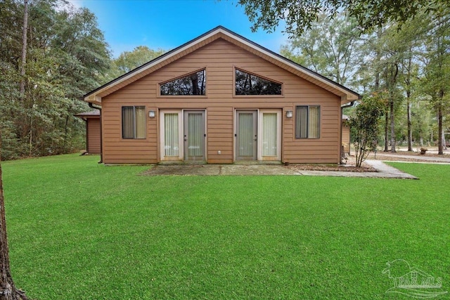 rear view of house with a lawn