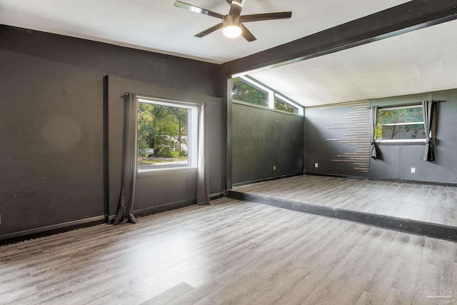 interior space with lofted ceiling with beams, light hardwood / wood-style floors, and ceiling fan