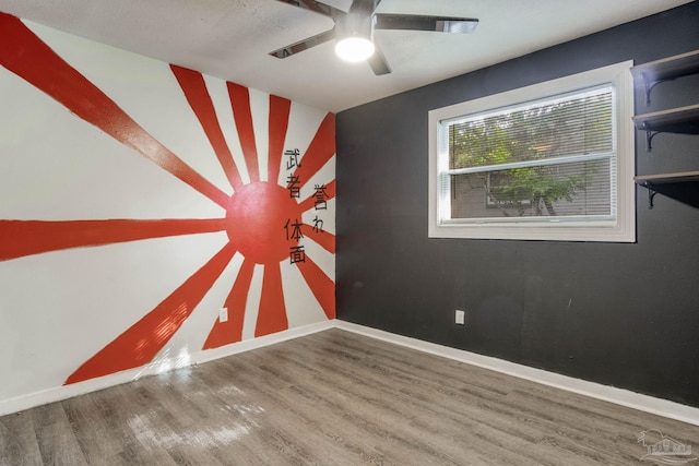 spare room with ceiling fan and hardwood / wood-style flooring