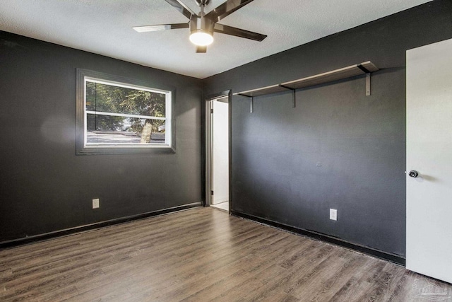 spare room featuring wood-type flooring and ceiling fan