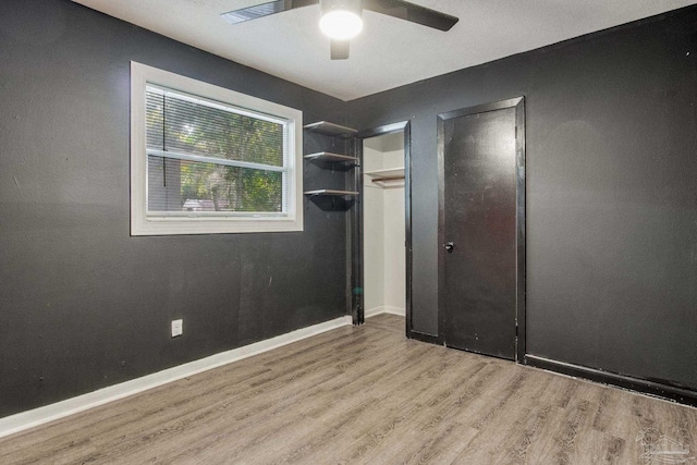 unfurnished bedroom with ceiling fan and light wood-type flooring