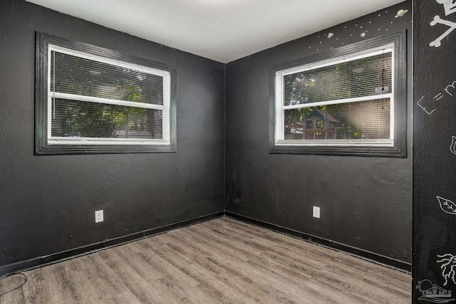 empty room with hardwood / wood-style floors