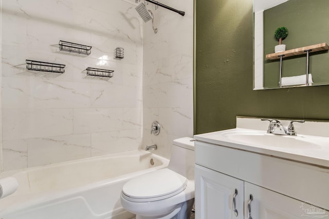 full bathroom featuring tiled shower / bath, vanity, and toilet