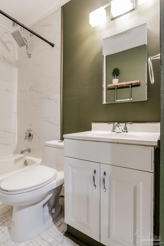 full bathroom featuring vanity, tiled shower / bath combo, and toilet