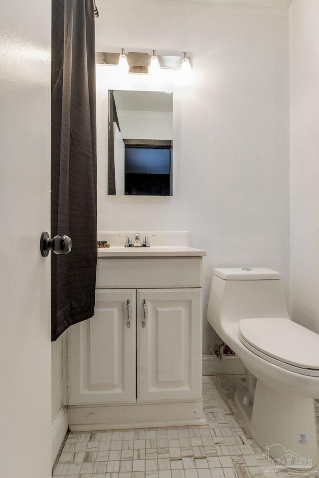 bathroom featuring vanity and toilet