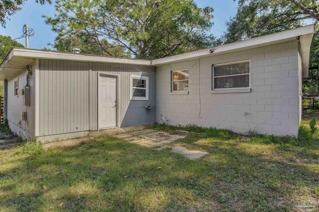 rear view of property with a lawn