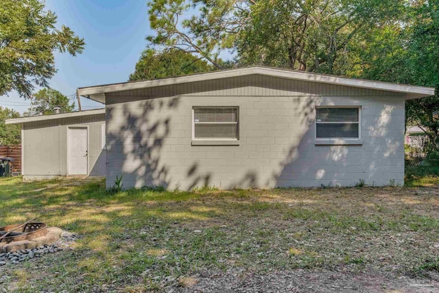 view of side of property with a fire pit