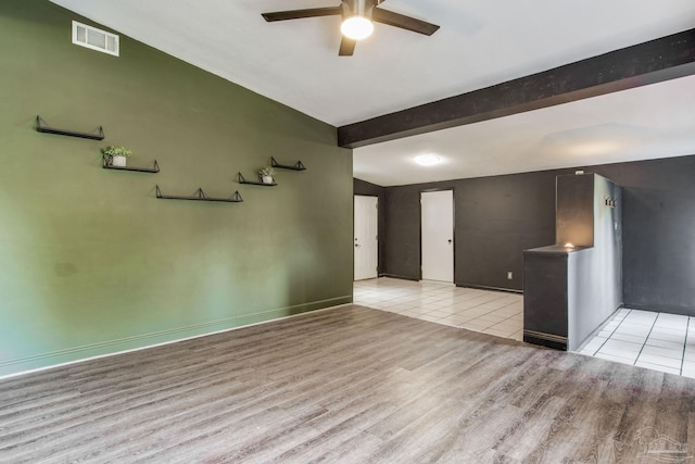 unfurnished living room with light hardwood / wood-style floors, beamed ceiling, and ceiling fan