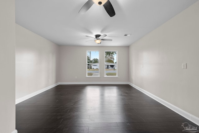 empty room featuring ceiling fan and dark hardwood / wood-style flooring