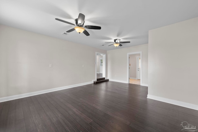 empty room featuring ceiling fan and dark wood-type flooring