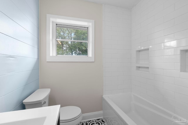 bathroom featuring toilet and tiled shower / bath combo