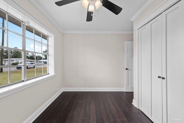 unfurnished bedroom featuring ceiling fan, multiple windows, crown molding, and dark wood-type flooring