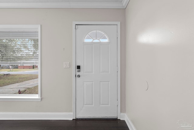 entryway featuring ornamental molding and dark wood-type flooring