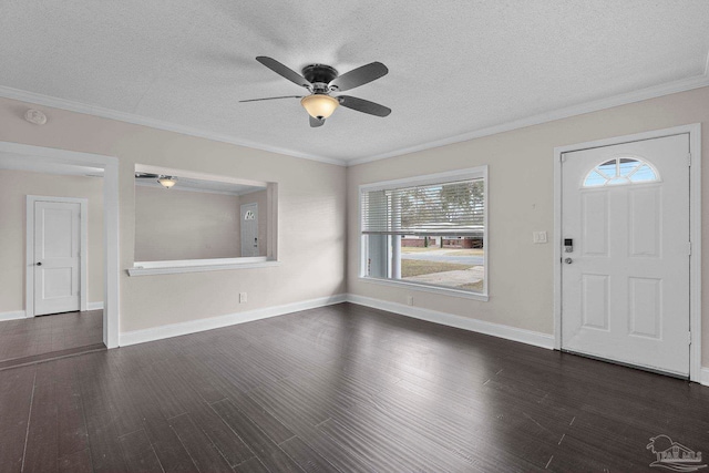 foyer entrance with dark hardwood / wood-style flooring, a textured ceiling, and crown molding